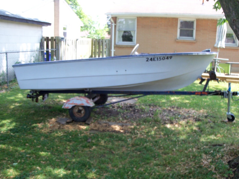 old boat ,old 1957 Evinrude 7.5hp outboard and trailer for sale