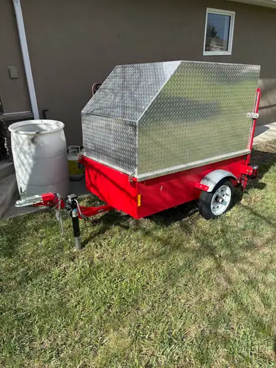 Small custom trailer for scooters and power wheelchair. Top hinges to front for easy access to tie d...