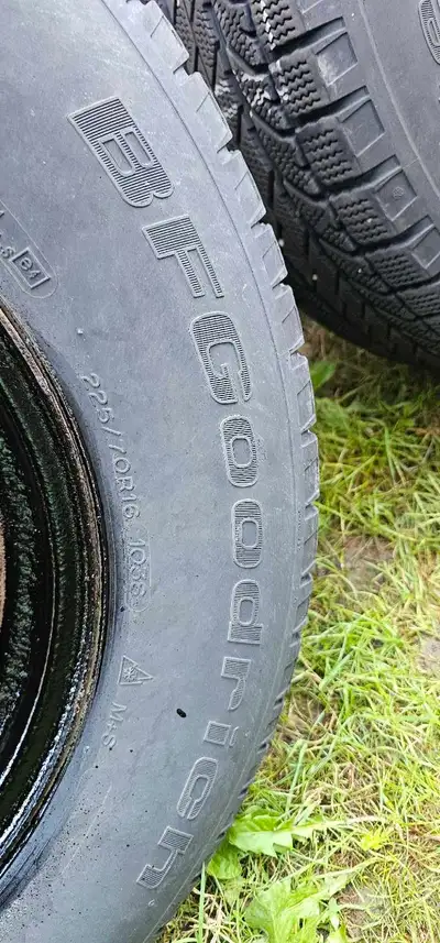 BFGoodrich 225/70R16 winter tires are mounted on black steel rims, providing reliable traction for c...