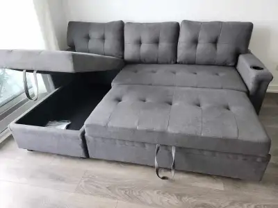 This brand new durable sectional sofa features a reversible chaise, offering versatility and comfort...