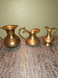Vintage brass pitchers.