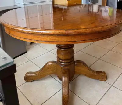 Gorgeous solid wood round table with pedestal base. Recently refinished for a warm, rich look. Varni...