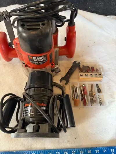 A pair of black and decker corded routers with bits, View more