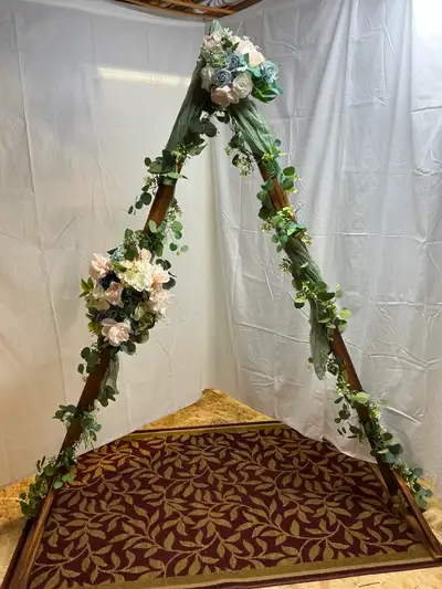 10 foot high triangle wedding arch. Artificial greenery and 2 lengths of sage green cheesecloth incl...