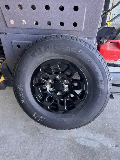Michelin X-Ice Snow tires on 16" black rims that came off of a 2014 Toyota FJ Cruiser. tires and rim...