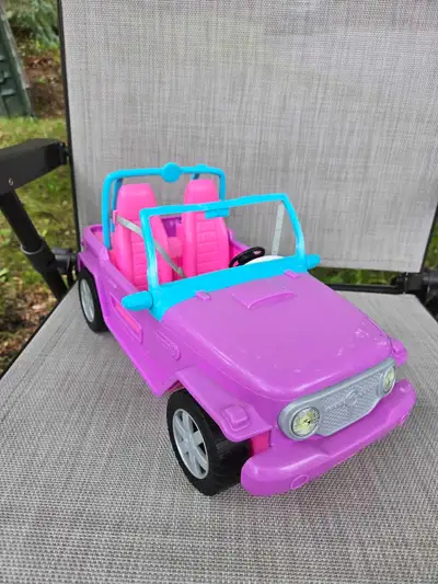 Barbie SUV in good used condition. Seats two Barbie dolls in the front and includes additional seati...