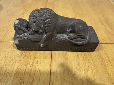 This striking Gargoyles Studio lion statue adds a noble touch to any space, depicting a resting lion...