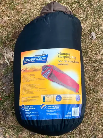 Used Broadstone mummy sleeping bag. Red and brown colour scheme. Features a plaid flannel liner. Lig...