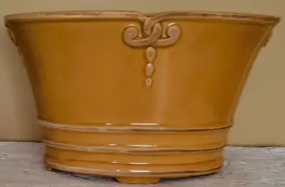FOOTED ORNATE GLAZED CERAMIC AMBER-COLOURED PLANT POT, View more