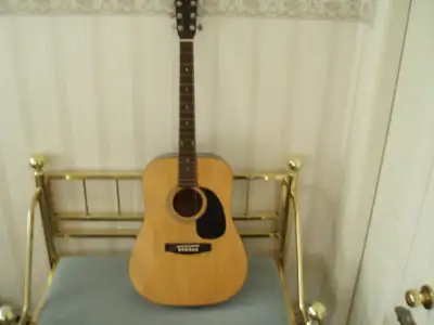 Selling a full size acoustic guitar. Spruce Top, Gloss Natural Finish, Agathis back & sides, multipl...
