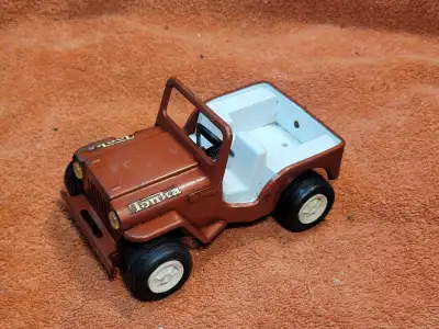 Explore the classic charm of the Vintage Pressed Steel Tonka Red Jeep, a true replica of the iconic...