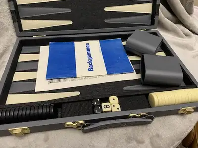 This backgammon set comes with everything you see it is complete with all the pieces and dice and cu...