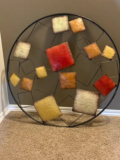 Add a touch of modern artistry to your living space with this eye-catching metal wall art piece, fea...