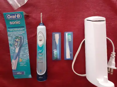 -- Oral-B Sonic brush + 2 brand new brush heads -- $25 ( first picture) -- Oral-B Braun charger with...