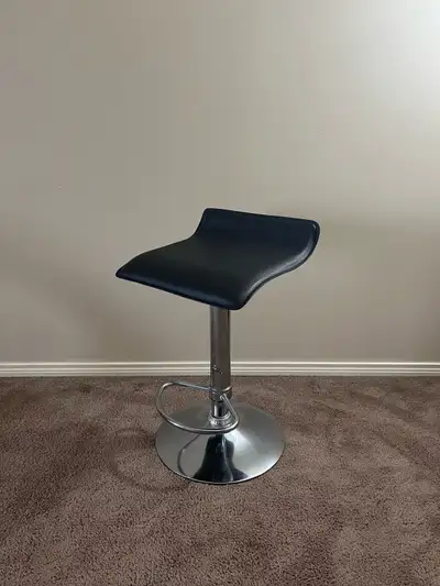 Black faux leather. Excellent condition. The seat adjusts from about 23.5 inches from the floor to a...