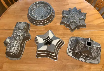 Five Wilton baking pans. 10 dollars each. Two of them are Bundt pans - the house and the star. The o...