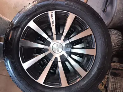 4 TIRES ON ALLOY RIMS WITH MULTI FIT 5 BOLT PATTERNS. 215 60R16 IN GOOD CONDITION. FITS MITSUBISHI A...