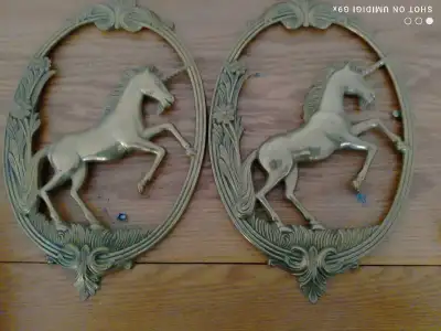 Add a touch of mythical charm to your home decor with this set of two vintage unicorn wall hangings....