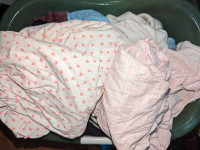 2x white and pink crib sheets