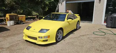 For sale is a striking yellow Nissan 300ZX, known for its sleek design and sporty performance, with...