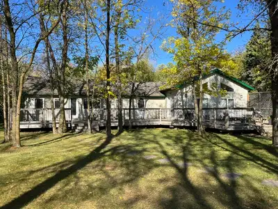 Well-cared for bungalow cottage on an extra-large double lot (.54 acre) with half log siding . The h...