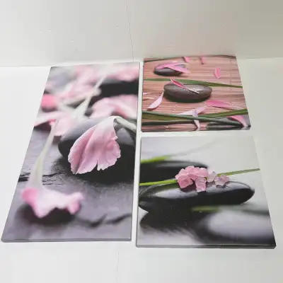 Spruce up your living space with this set of three canvas prints, each depicting serene spa stones a...