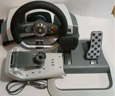 I am selling my Xbox 360 which comes with a wireless steering wheel and pedals, extra steering wheel...