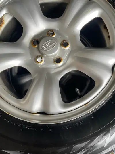 Set of four Excellent Bridgestone Blizzak winter tires with original Subaru rims. The tire number is...
