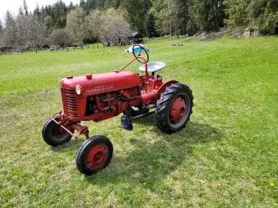 Gasoline engine Farmall Cub tractor. Runs great, good condition. Has a field mower attachment (not p...