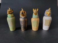 SET OF 4 DECORATIVE EGYPTIAN CANOPIC JARS.