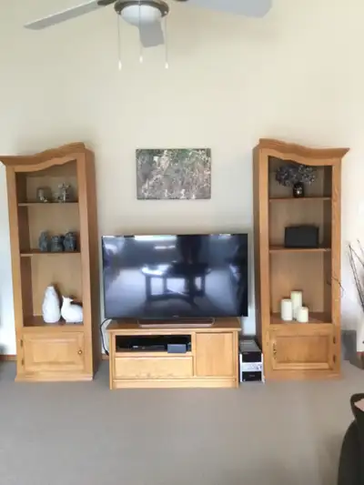 2 oak bookcases. Decorative top, moveable shelves. 71x23x15 inches each. Does not include tv and tv...