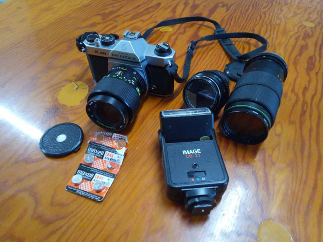 Pentax K1000 + 3 lenses and flash, sell or swap for DSLR in Cameras & Camcorders in Petawawa
