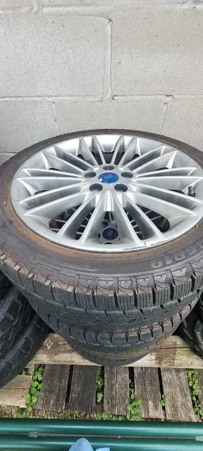Selling a set of four 2013 Ford Fusion aluminum wheels, complete with tire pressure sensors and wint...