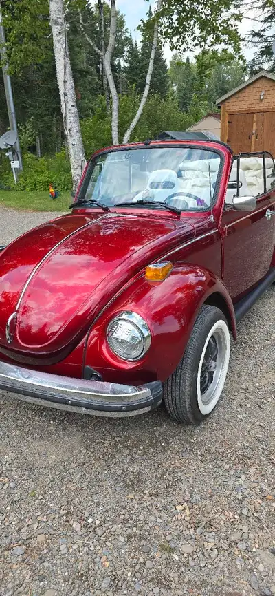 This is a used 1978 VW Super Beetle Convertible, boasting a vibrant red exterior and a classic conve...