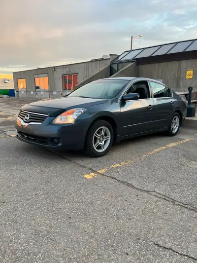 Dark grey with grey cloth. Nice import sedan, no warning lights on dash. 4cylinder that is Reliable...