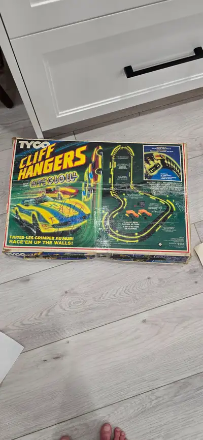 Selling a Tyco cliff hangers nitro glow electric slot car race track. In the original box. It has al...