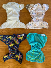 8 Like new Cloth Diapers and lots of liners 