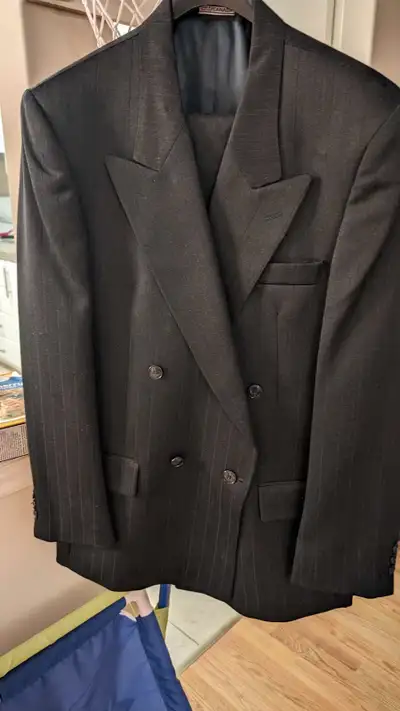 Like new, worn only a few times Dry cleaned Black Suit with thin blue pinstripes. Size 38 jacket, si...