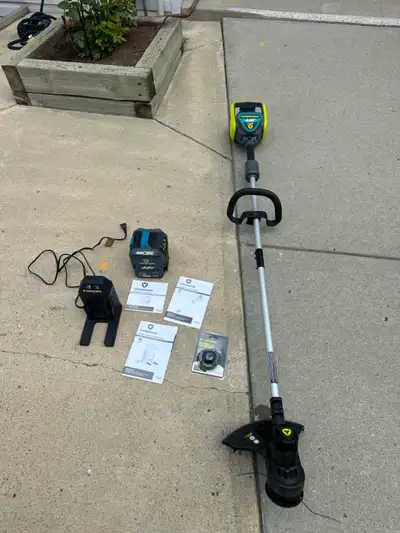 Yardworks 13” bump feed twin line 48 volt grass trimmer. Comes with 48 volt 2.0 ah battery and charg...
