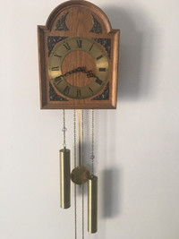 Vintage AMS Germany weight driven wooden wall clock.