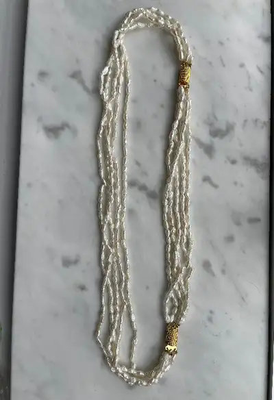 One natural Keishi pearl torsade-style necklace with five strands of off-white pearls. Costume jewel...