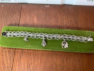 Vintage Dynasty sterling silver woven charm bracelet with three sterling silver charms. Marked “STG....