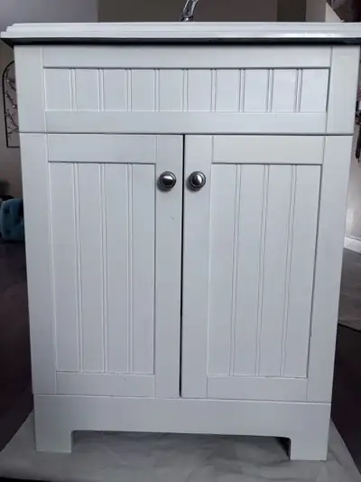 24” bathroom vanity with sink and 23” wall cabinet. Both in good shape.