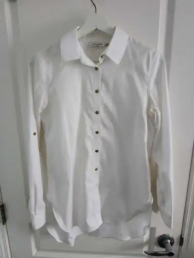 This is a Calvin Klein white button-up shirt, perfect for a professional or casual look! This shirt...