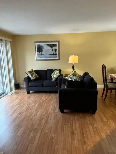 Condo open concept with spacious living room, dining room and kitchen with large patio door that fil...