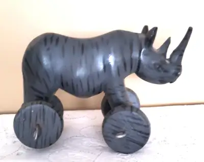 HANDCRAFTED WOODEN RHINOCEROS TOY ON 4 WHEELS, View more
