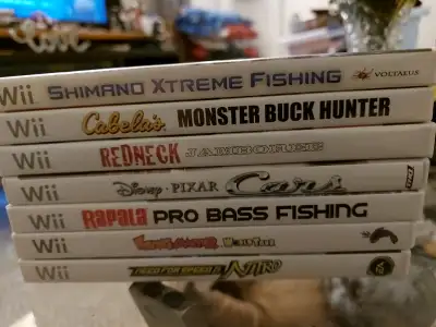 Mint Wii games in cases with the books Cabela's Monster Buck Hunter $8 Calvin Tucker's Redneck Jambo...
