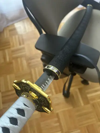 Replica katana. I believe it’s from a game or show. Unsharpened stainless steel, likely some alloy o...