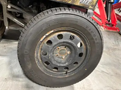 Four Firestone Winterforce 2 UV winter tires (P245/65R17, 105S) mounted on steel rims. Studdable win...