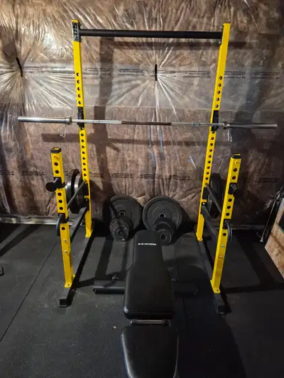 Squat/bench rack with 45lb 7ft olympic bar, 2x45 lb plates, 4x35 lb plates, 2x25 lb plates, 2x10 lb...